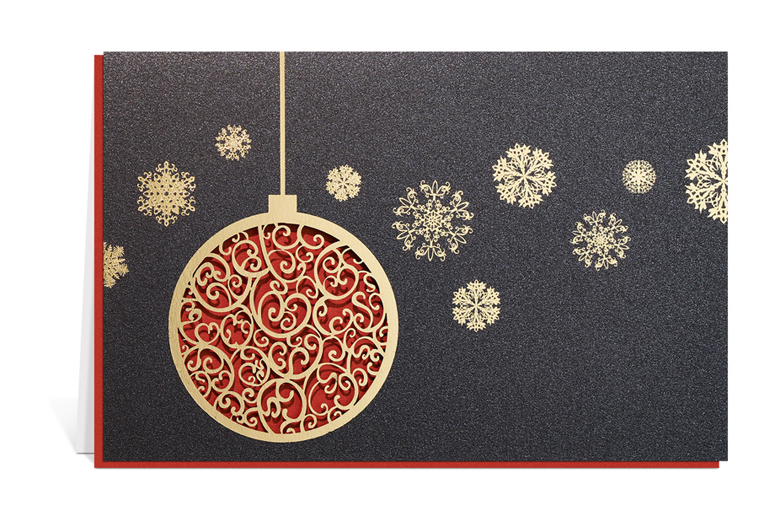 Dunkle Weihnachtskarte mit goldenen Schneeflocken und einer Christbaumkugel, aus der die Ornamente gestanzt sind, als Inlay ein rotes Papier