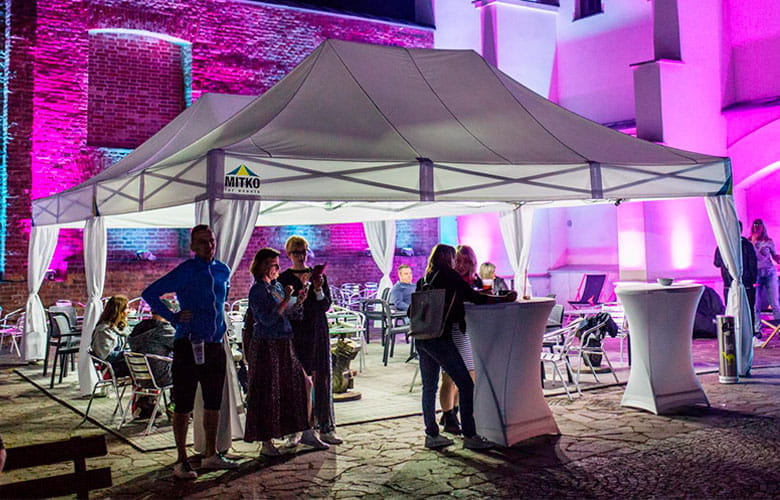 Octa Pro LED auf Veranstaltung Veranstaltung mit dem Produkt 'Octa Pro LED', Zelt mit Beleuchtung, Gäste stehen um Stehtische.