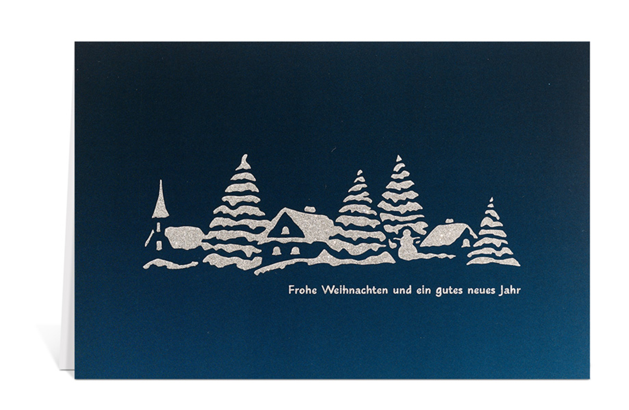 Blaue Weihnachtskarte mit der Silhouette von einem verschneiten Dorf und dem Text: Frohe Weihnachten und ein gutes neues Jahr